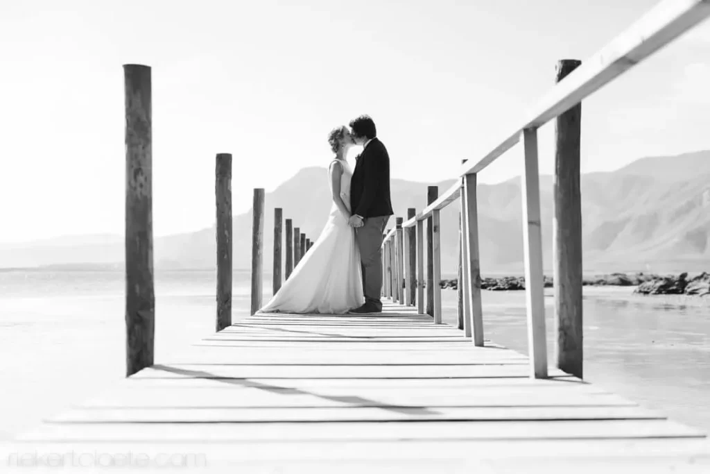 stellenbosch couple kissing wooden jetty over dam