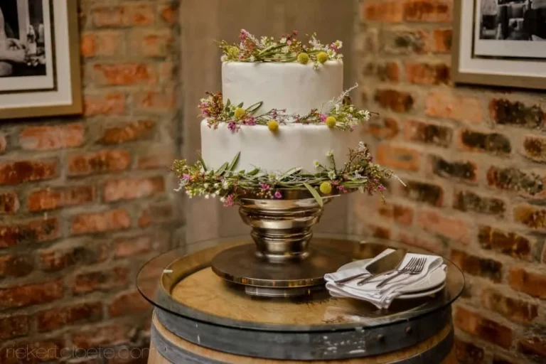 two tier white cake wildflowers wine barrel
