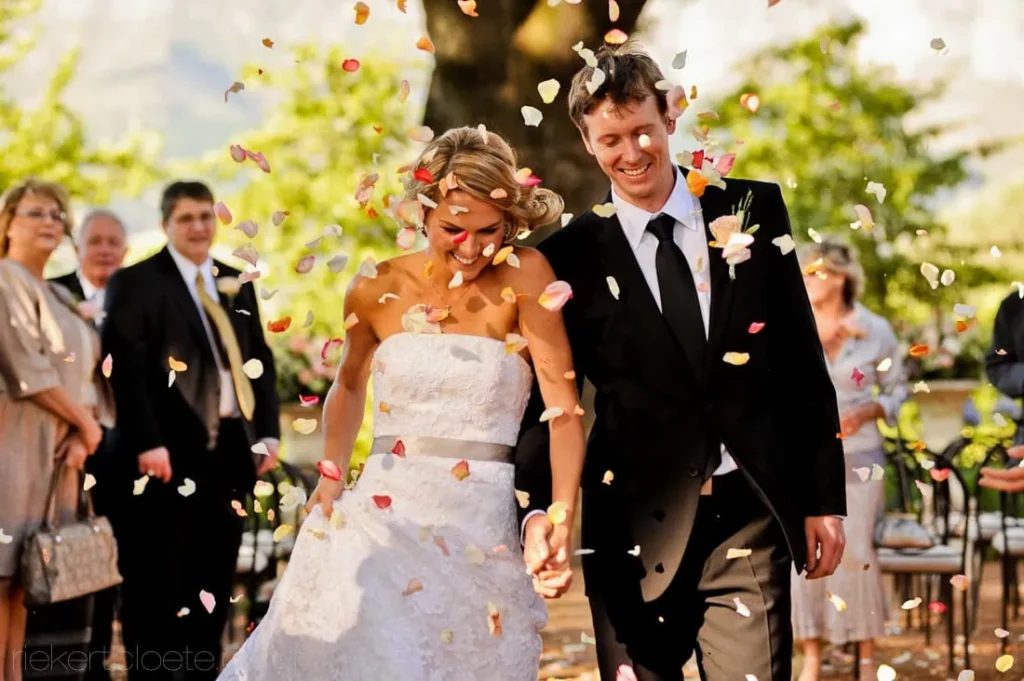 v Le Petit Dauphine couple colorful rose petals autumn tree ceremony