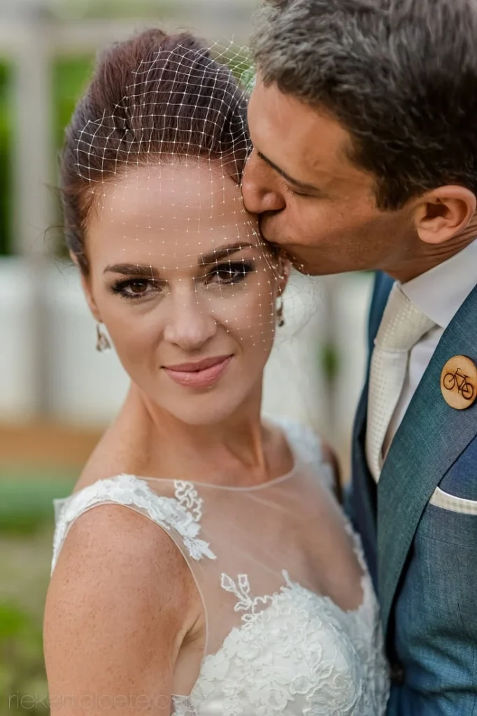 vrede en lust bride birdcage veil groom teal suit