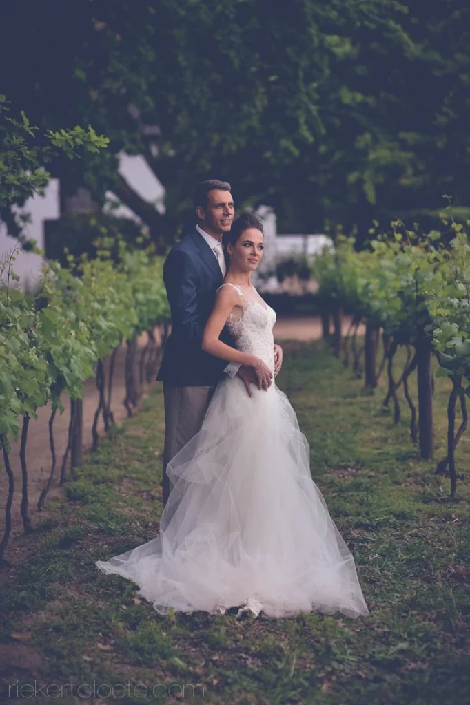 vrede en lust couple vineyard rows lace gown