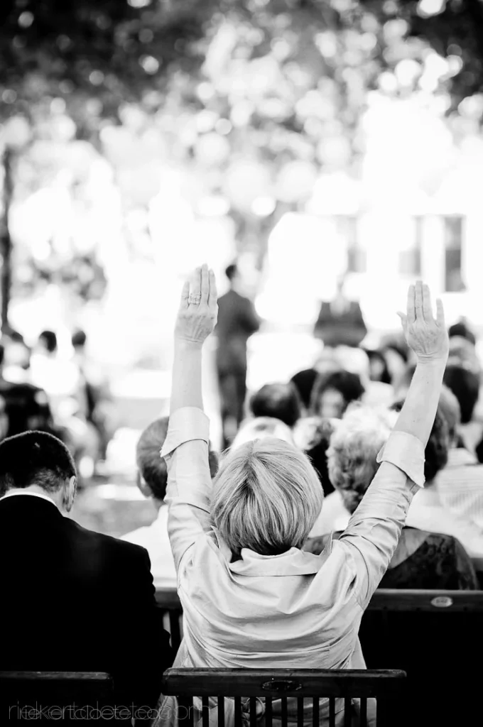 wedding guest raised hands worship outdoor ceremony