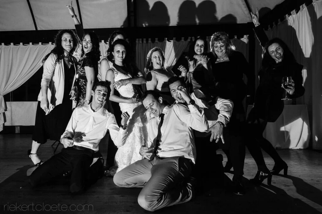 wedding party playful group pose dance floor