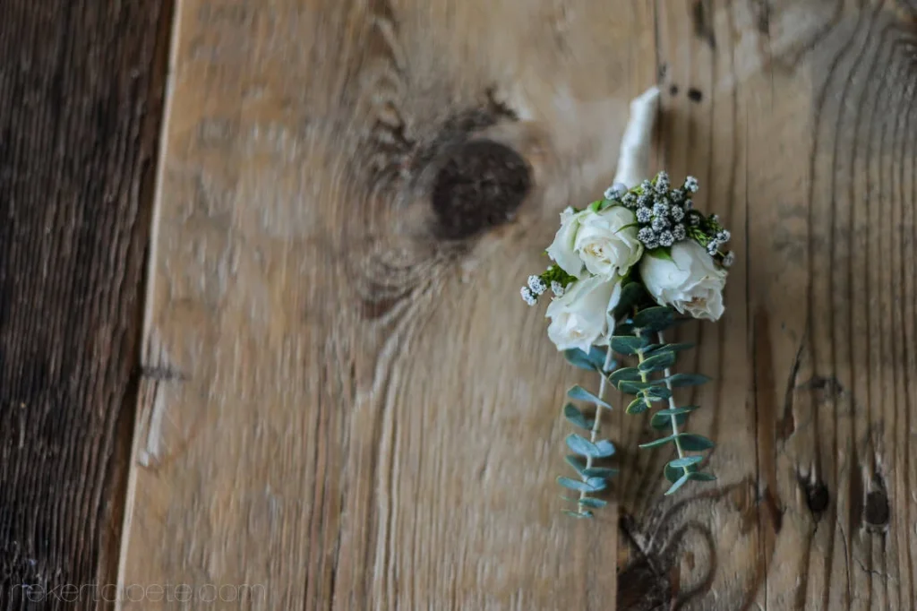 white rose boutonniere eucalyptus rustic wood wedding