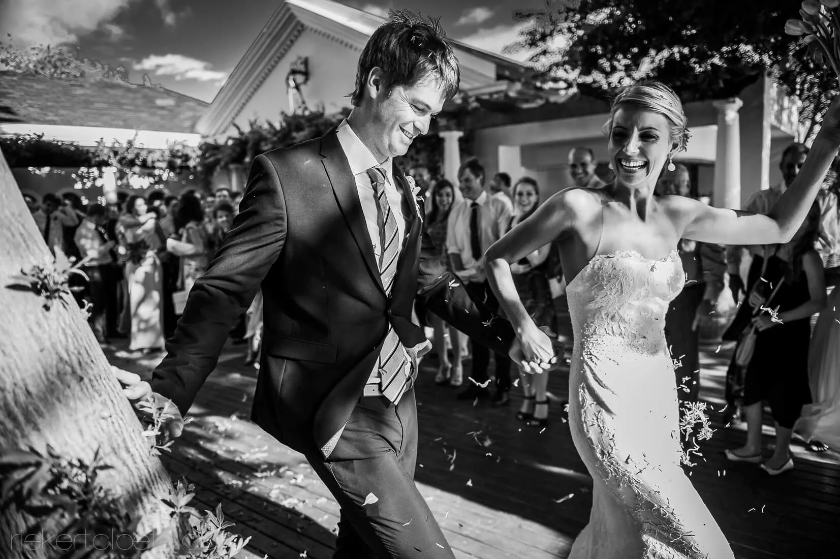 Couple running joyful confetti exit veranda venue – Bakenhof, Paarl