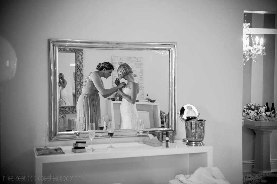 Bridesmaid buttoning dress reflected dressing mirror – Brenaissance Wine Estate, Stellenbosch