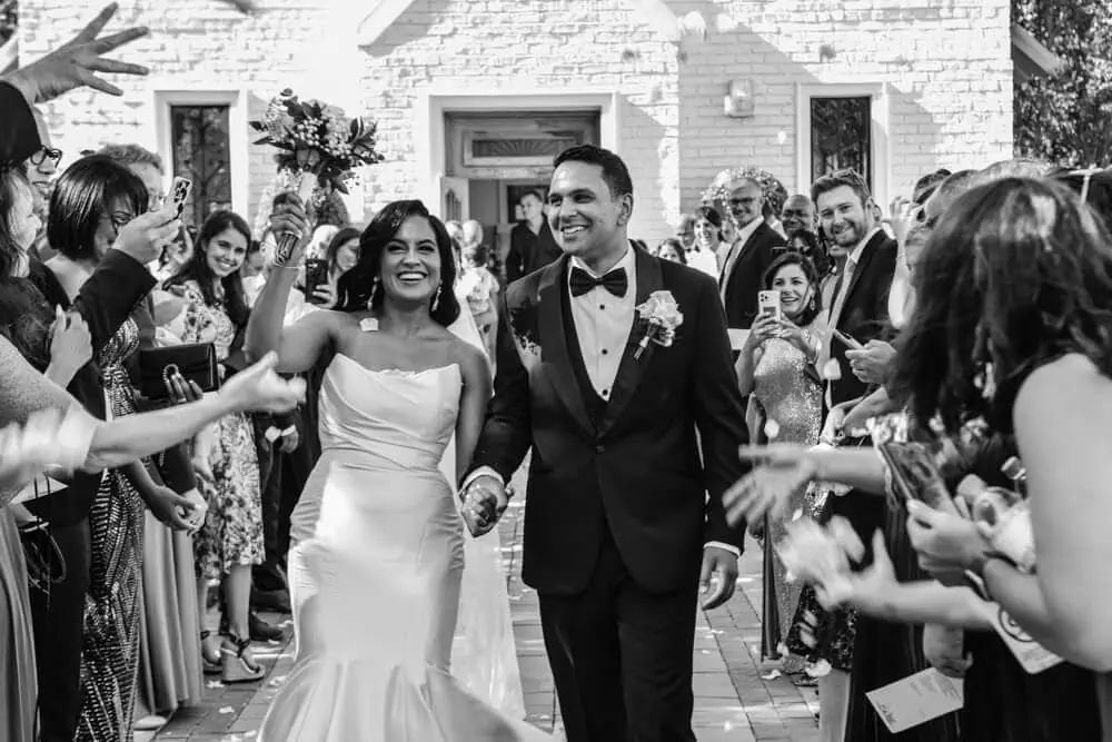 Couple confetti exit brenaissance black tuxedo – Brenaissance Wine Estate, Stellenbosch