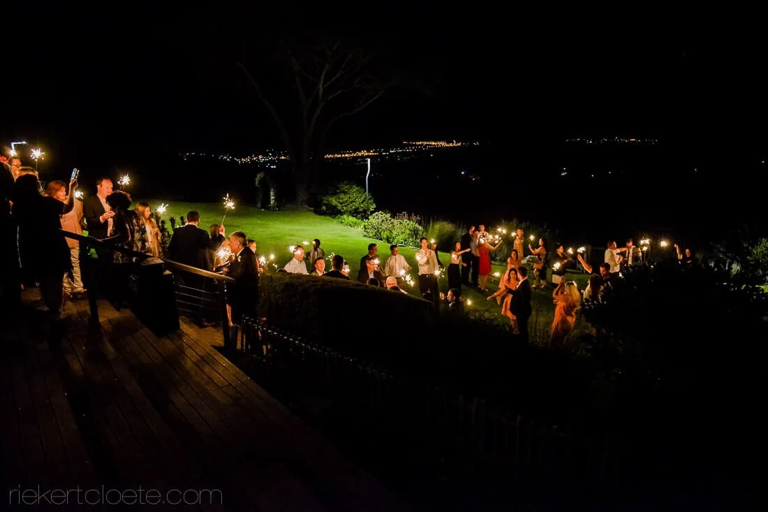 Wedding sparkler exit deck city lights night – Cape Point Vineyards, Cape Town