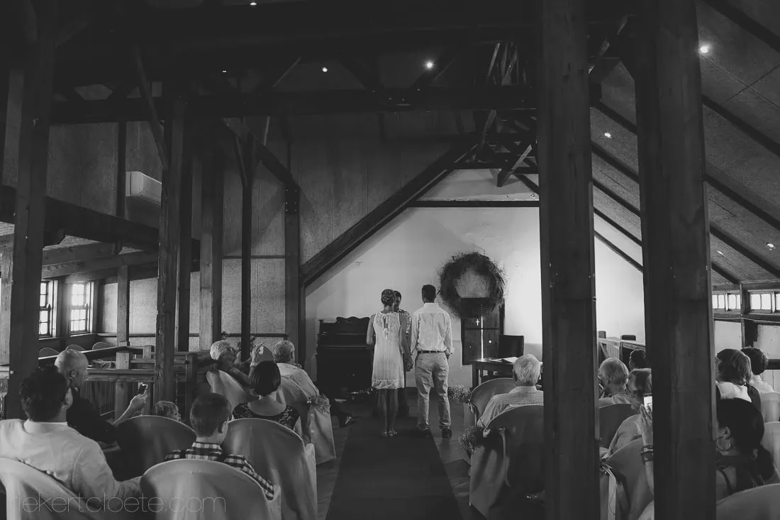 Indoor barn ceremony couple altar rustic wooden beams – De Malle Meul, Riebeek Valley & Swartland