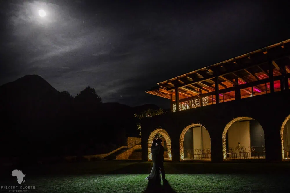 Diamant estate couple silhouette moonlit stone arches – Diamant Estate, Paarl