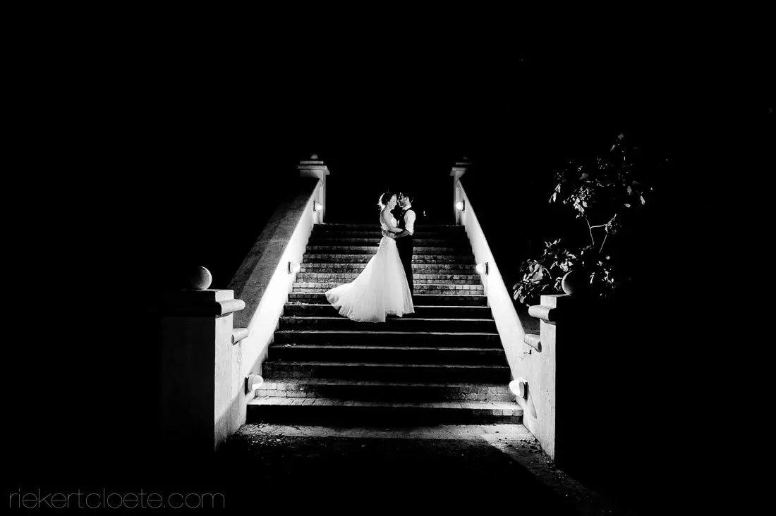 Couple standing grand stone staircase night black white – Groot Constantia, Cape Town