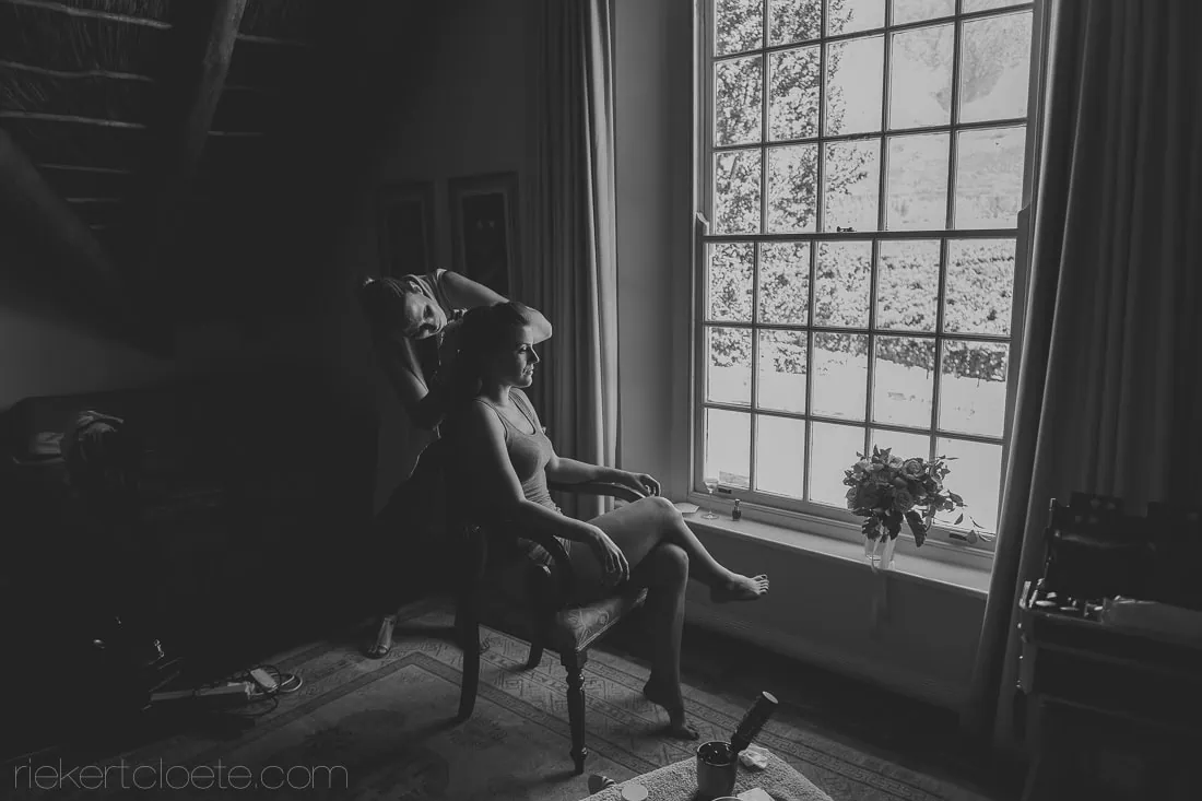 Bride hair styled chair window documentary style – Holden Manz Wine Estate, Franschhoek