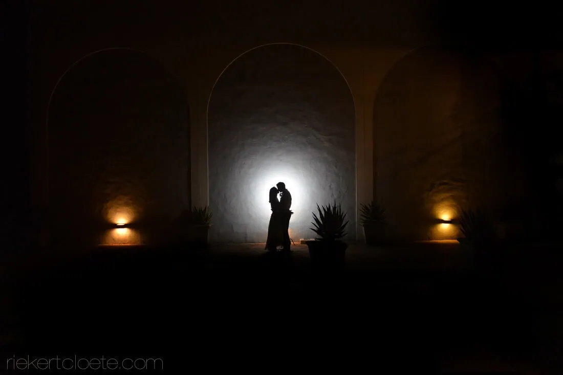 Couple silhouette glowing archway lanterns night – Holden Manz Wine Estate, Franschhoek