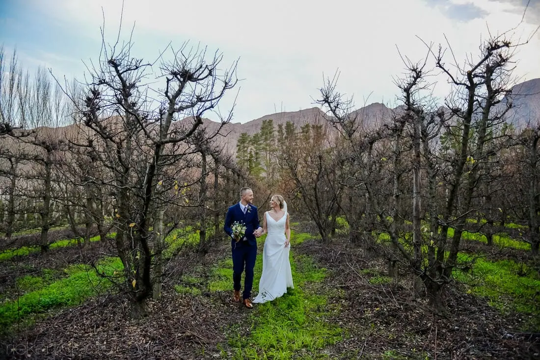Stellenbosch couple bare orchard mountain backdrop – Holden Manz Wine Estate, Franschhoek
