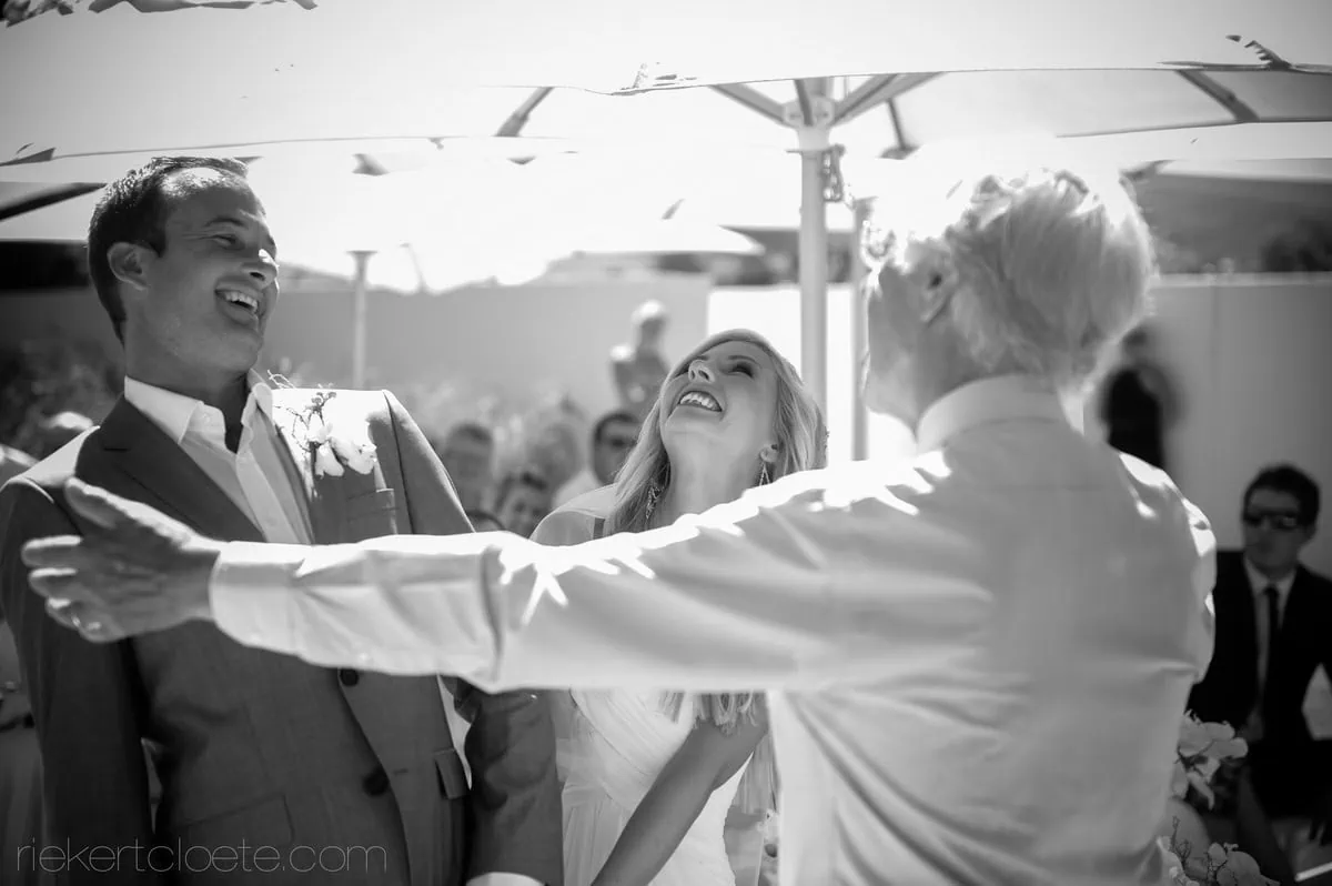 Candid joyful embrace couple outdoor ceremony – Maison Estate, Franschhoek