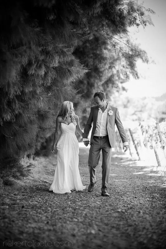 Couple gravel path overhanging trees moody – Maison Estate, Franschhoek