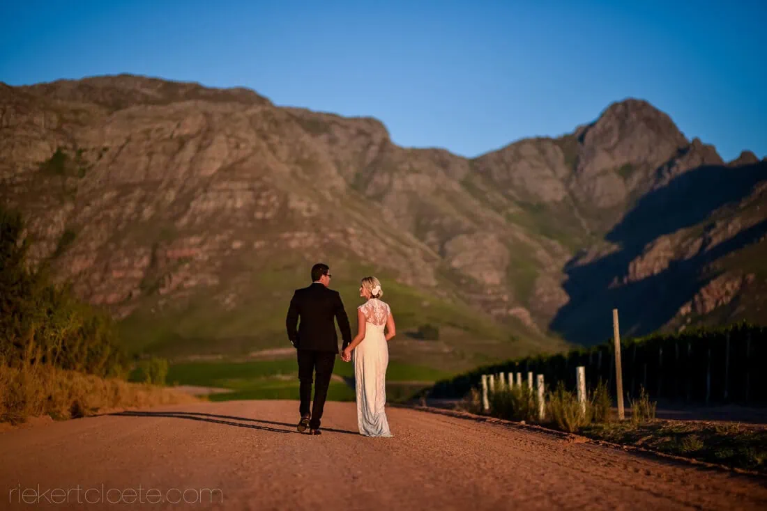 Couple walking red dirt road sunset mountain – Mont Marie, Stellenbosch