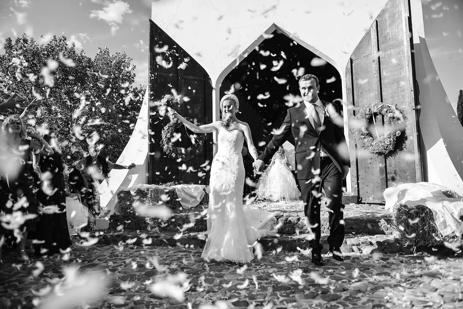 Couple dramatic confetti burst exiting barn chapel – Montpellier Wine Estate, Tulbagh