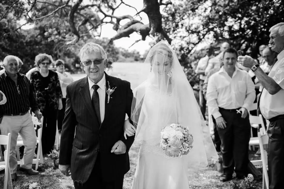 Father escorting bride down outdoor aisle guests – Mosaic Lagoon Café, Hermanus
