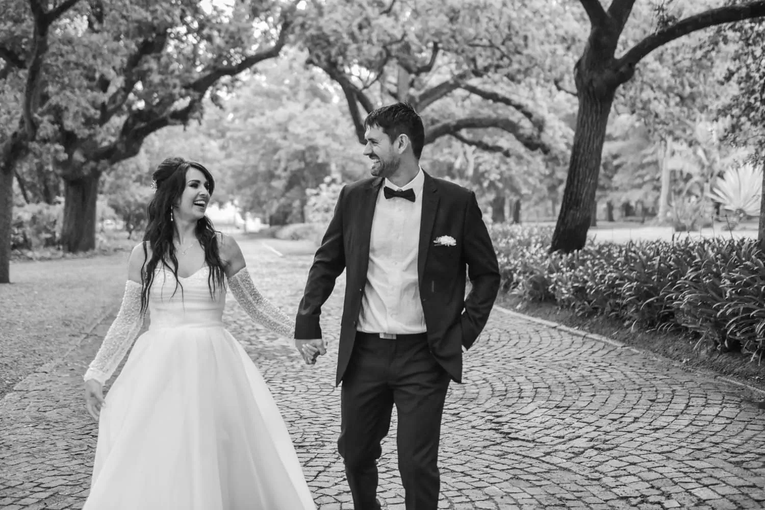 Black white couple cobblestone path oak trees – Nooitgedacht Estate, Stellenbosch