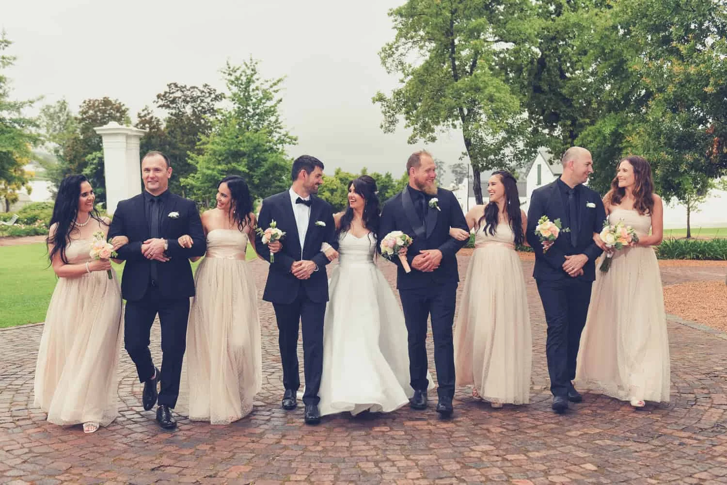 Wedding party cape dutch estate champagne black tuxedos – Nooitgedacht Estate, Stellenbosch