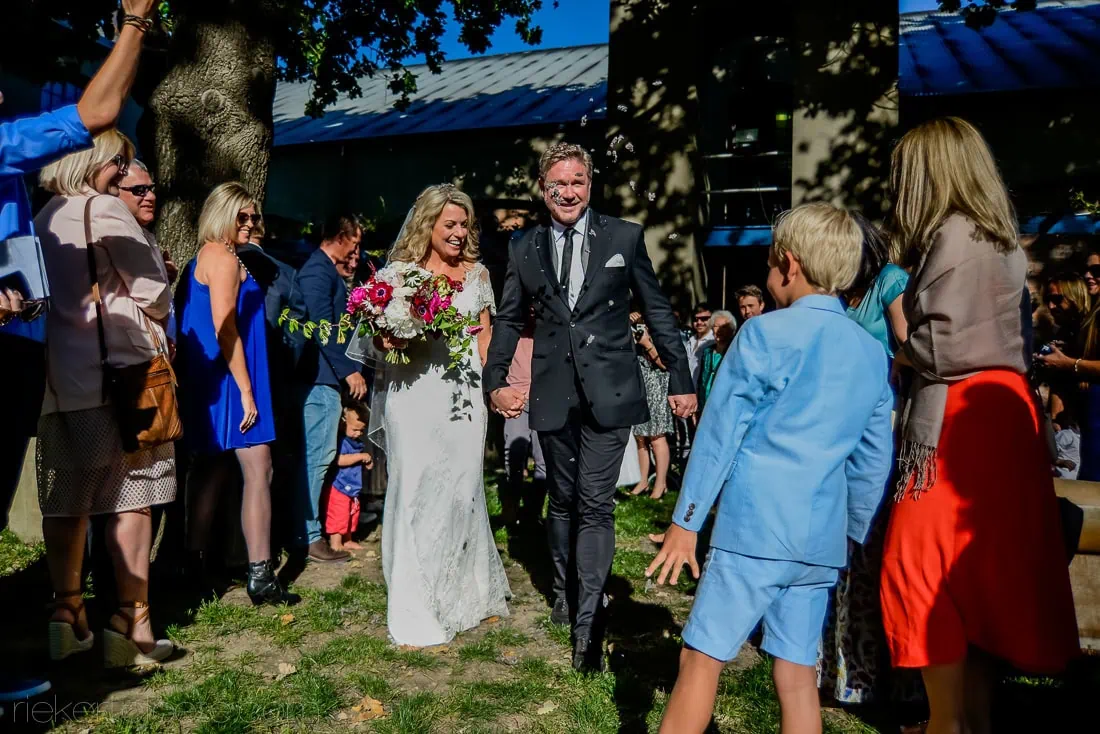 Bride groom walking through cheering guests outdoors – Saronsberg Wine Cellar, Tulbagh