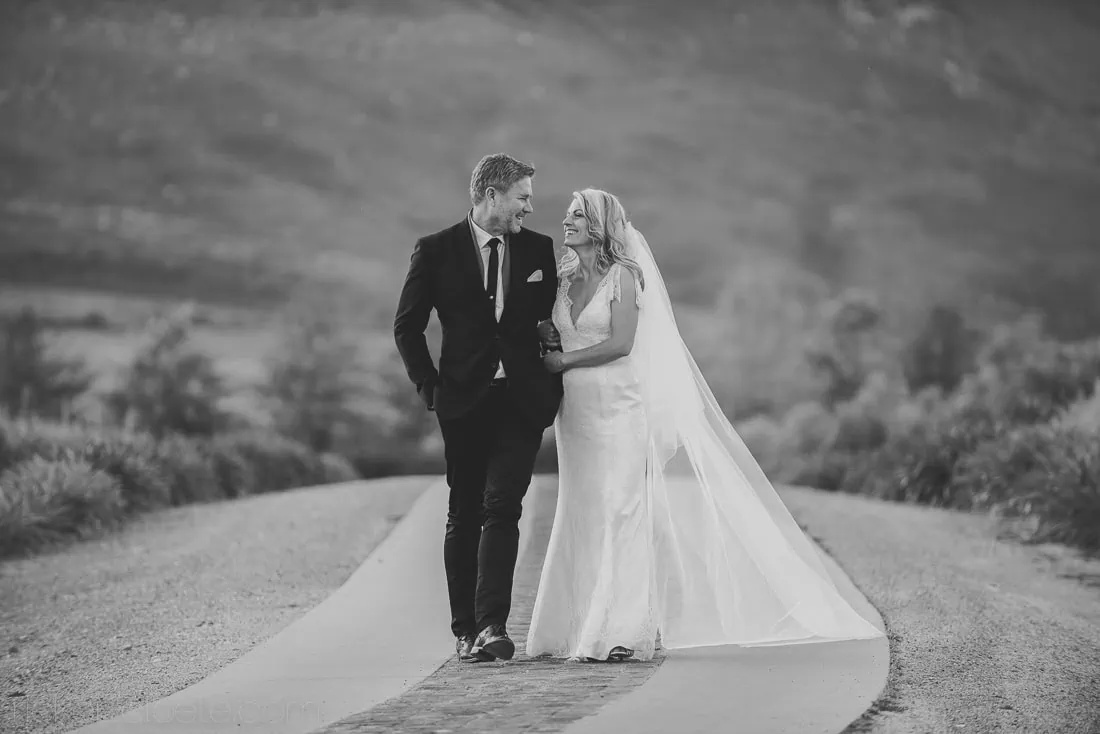 Couple laughing on road veil flowing black white – Saronsberg Wine Cellar, Tulbagh