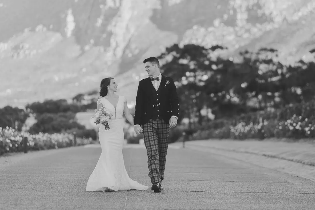 Black white couple paved path dramatic mountain – Steenberg Hotel, Cape Town