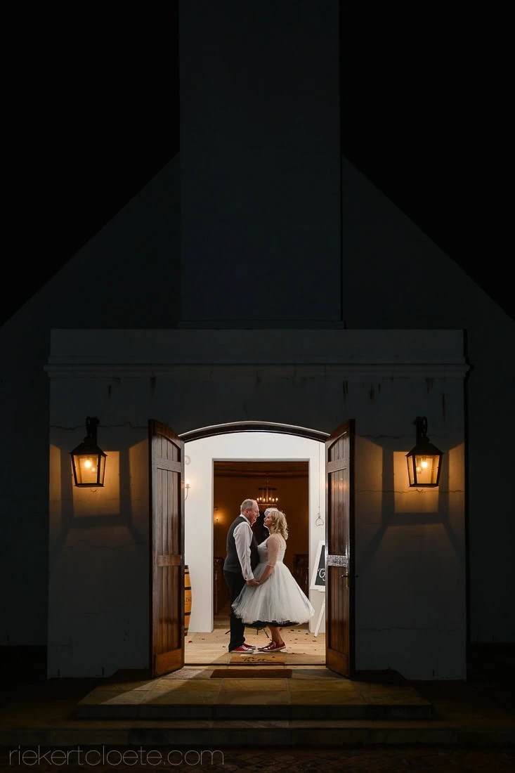 Couple silhouette cape dutch church doorway night – Vondeling Wines, Paarl