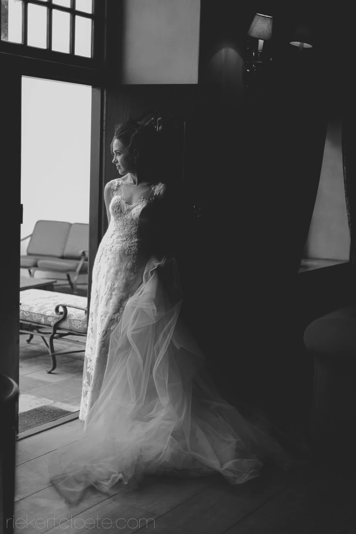 Vrede en lust Bride lace gown doorway window light – Vrede en Lust Wine Estate, Franschhoek