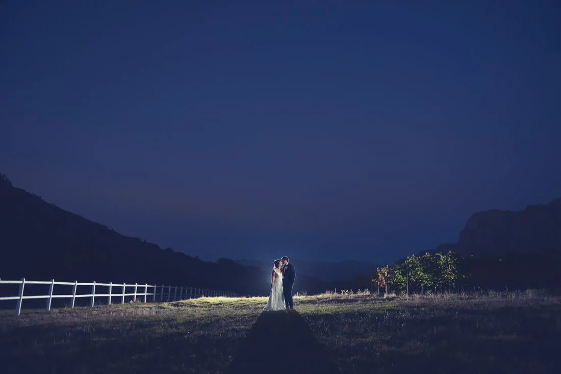 Couple kissing farm field night white fence mountains – Zorgvliet Wine Estate, Stellenbosch
