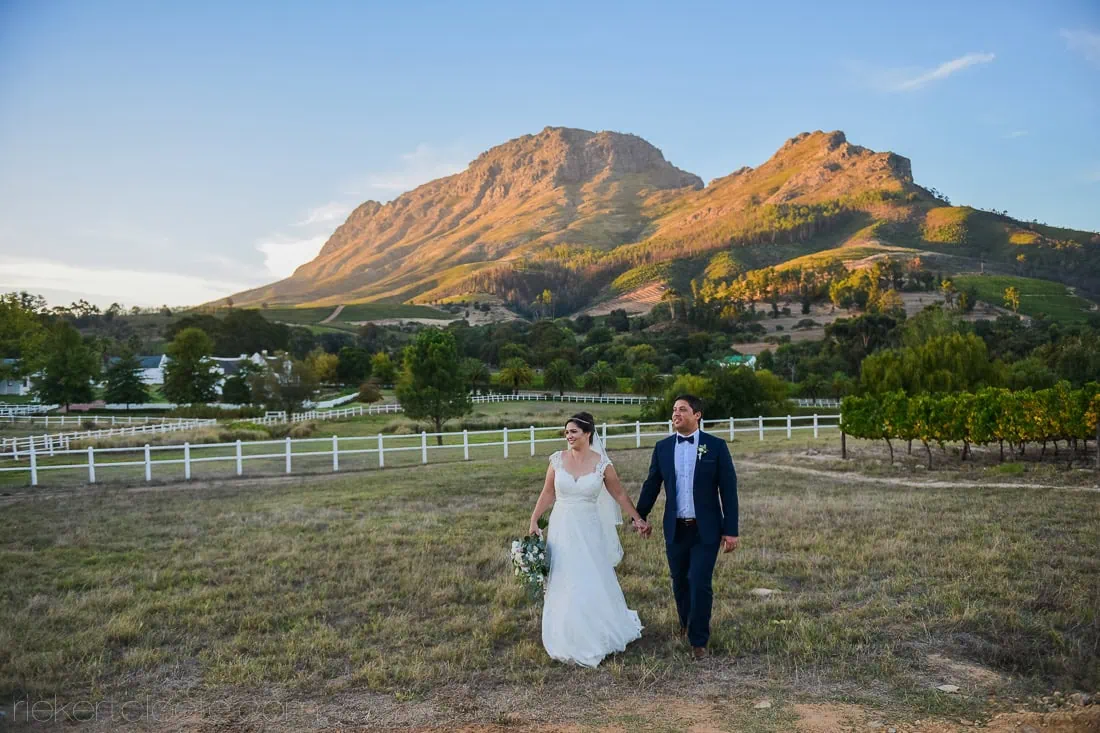 Couple vineyard estate white fence mountain sunset – Zorgvliet Wine Estate, Stellenbosch