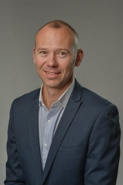 professional headshot of man looking at camera
