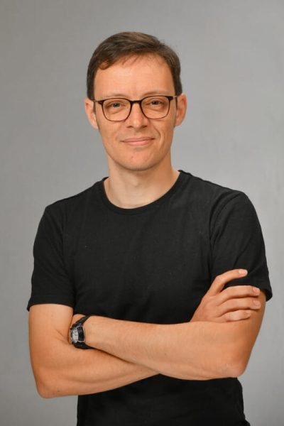 HEadshot of man folding arms